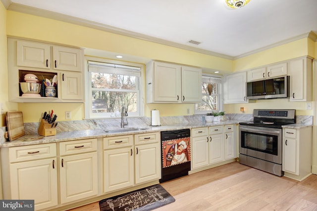 kitchen featuring light wood-style flooring, a sink, visible vents, ornamental molding, and appliances with stainless steel finishes