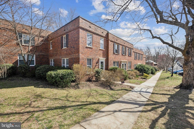 view of property exterior featuring a lawn and brick siding