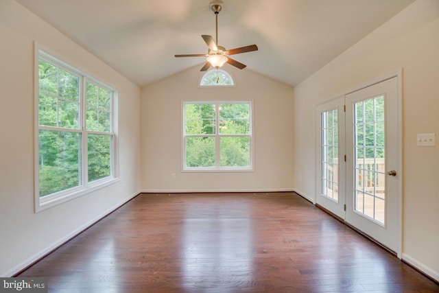 empty room with plenty of natural light, lofted ceiling, dark wood-type flooring, and a ceiling fan