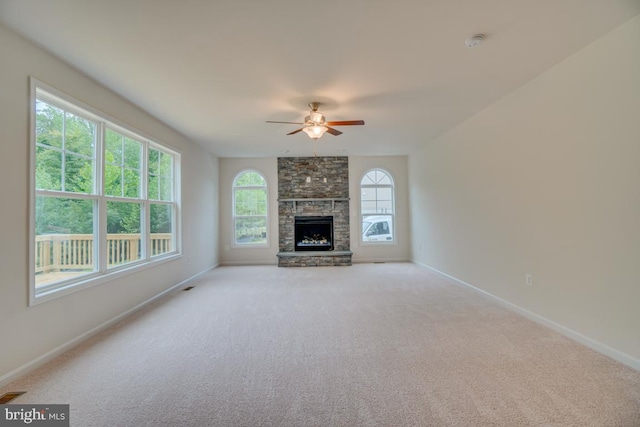 unfurnished living room featuring baseboards, a ceiling fan, and light colored carpet