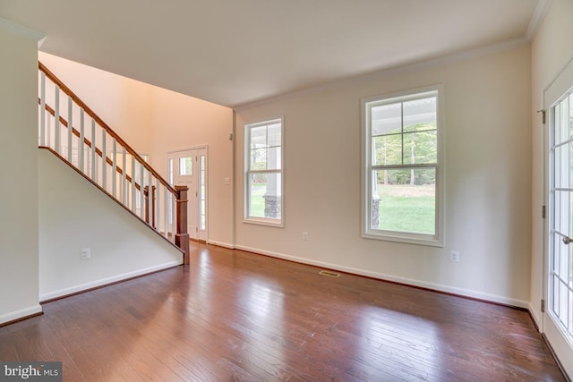 entryway with hardwood / wood-style floors, plenty of natural light, and stairs