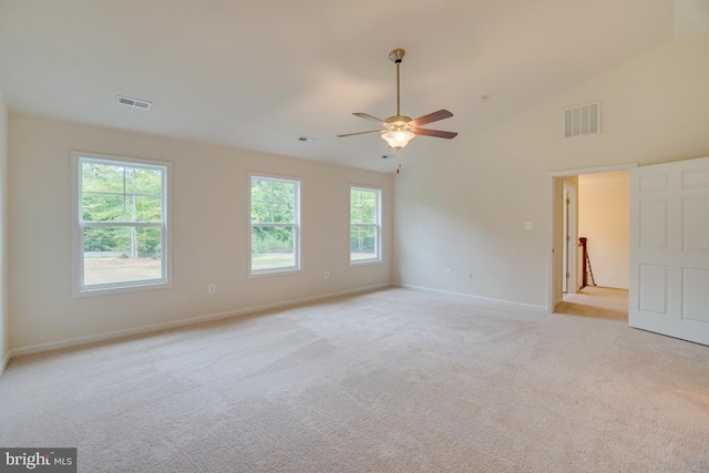 unfurnished room featuring ceiling fan, high vaulted ceiling, light colored carpet, and visible vents