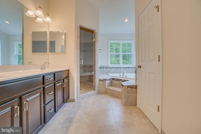 bathroom with tile patterned floors, a sink, a stall shower, a garden tub, and double vanity