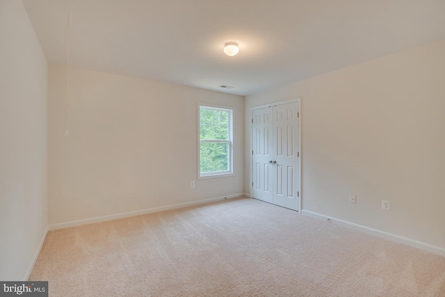 carpeted spare room with baseboards