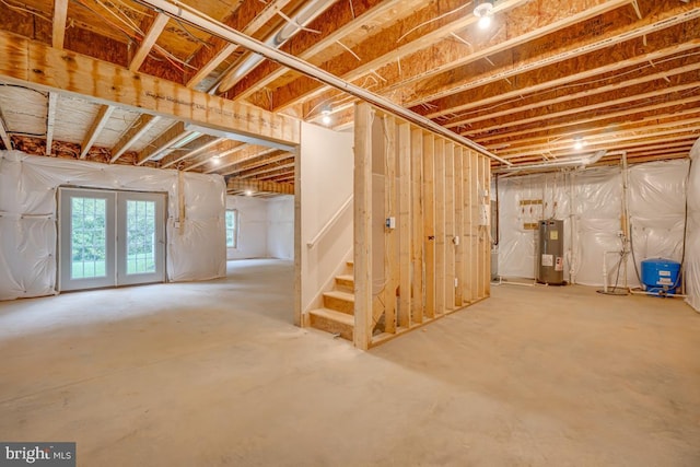 basement with stairs and electric water heater