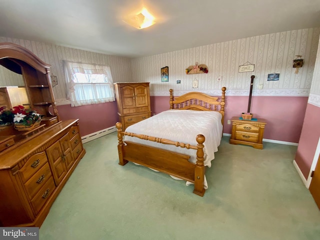 bedroom with carpet floors, wallpapered walls, baseboards, and a baseboard heating unit