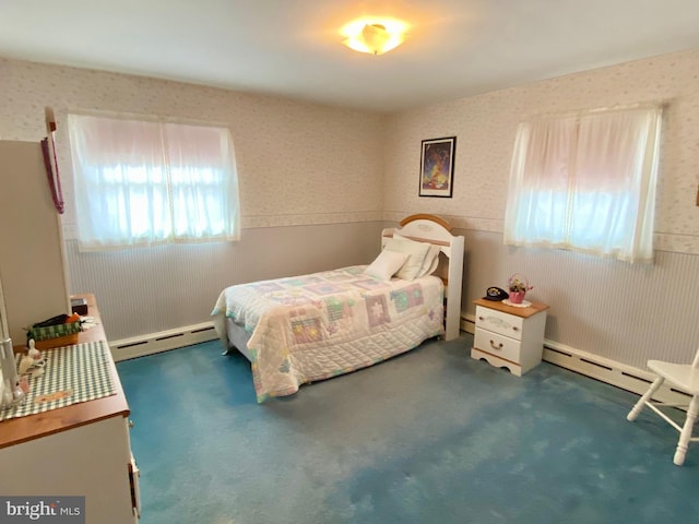 carpeted bedroom featuring a baseboard heating unit, a wainscoted wall, and wallpapered walls