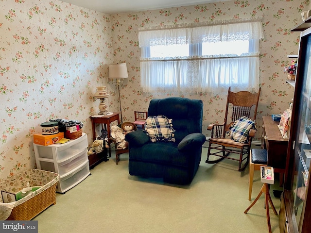 sitting room featuring carpet and wallpapered walls