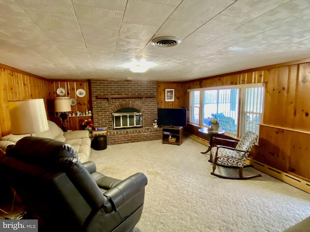 living area with wood walls, carpet, a brick fireplace, and visible vents