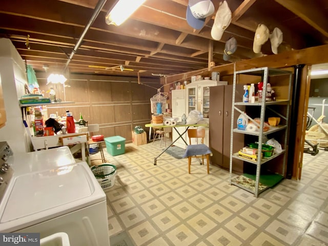 unfinished basement featuring washer / dryer and tile patterned floors