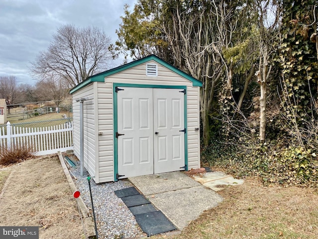 view of shed with fence