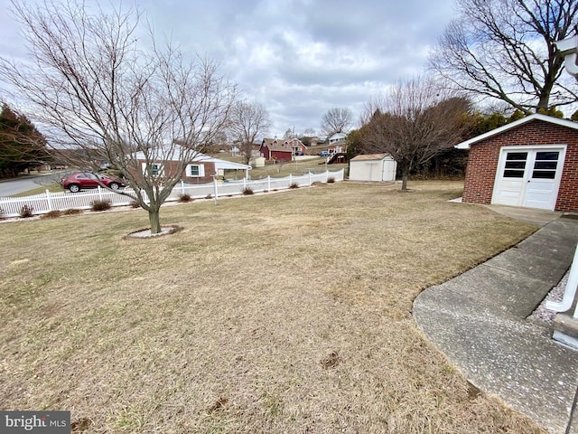 view of yard featuring an outdoor structure and fence