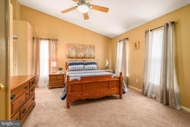 bedroom featuring lofted ceiling, baseboards, a ceiling fan, and light colored carpet