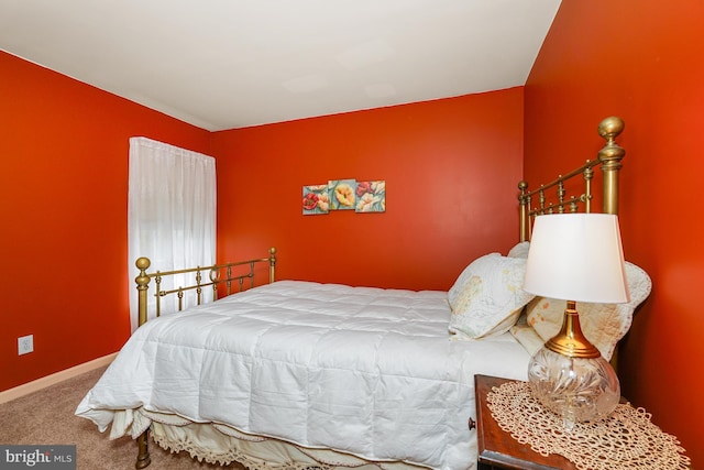 bedroom featuring carpet and baseboards