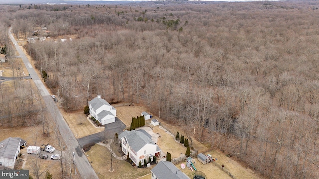 birds eye view of property with a forest view