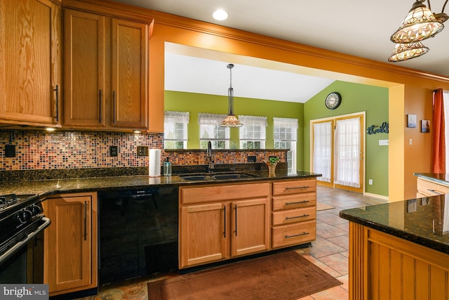 kitchen with a sink, decorative backsplash, brown cabinets, black appliances, and pendant lighting