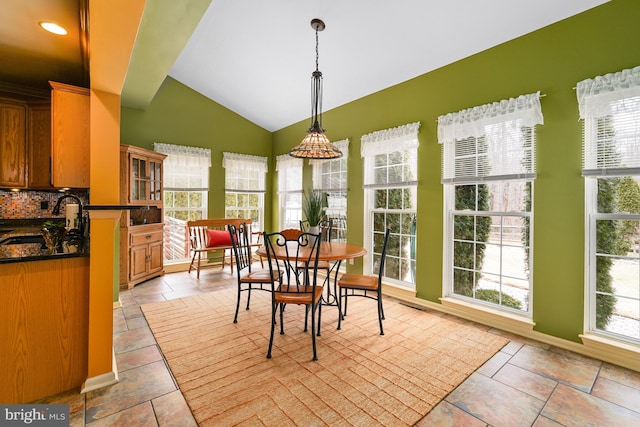 dining area featuring lofted ceiling, recessed lighting, and light tile patterned flooring