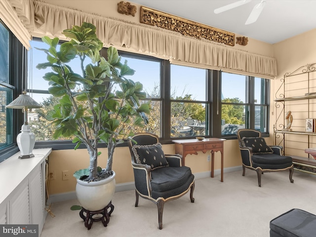 sunroom / solarium featuring a ceiling fan