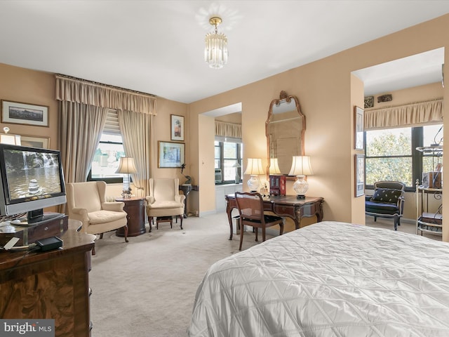 bedroom featuring carpet flooring and a notable chandelier