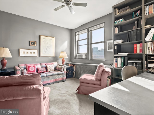 carpeted living room with ceiling fan