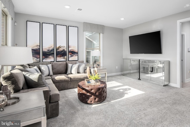 living area with recessed lighting, visible vents, baseboards, and carpet