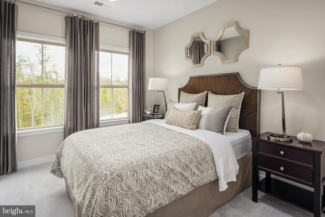 carpeted bedroom with visible vents and baseboards