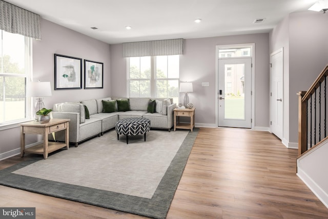 living area featuring visible vents, wood finished floors, recessed lighting, stairway, and baseboards