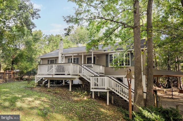 rear view of property featuring a wooden deck, stairs, and a yard