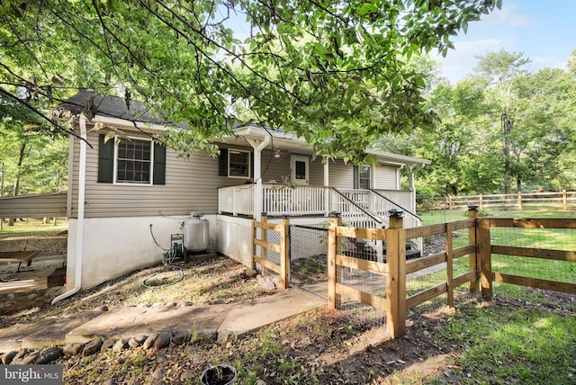 view of front of property with a porch and fence