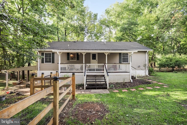 view of front of house with a deck, a front lawn, and stairs