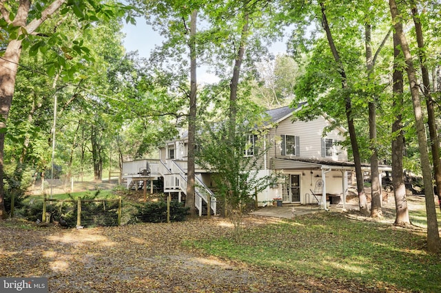 back of house with stairs and a patio area