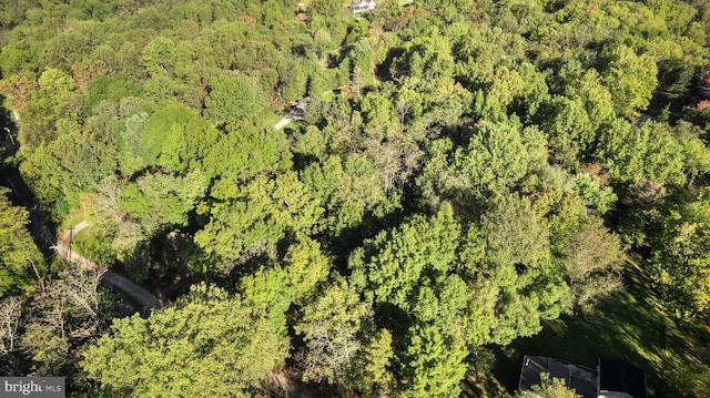 birds eye view of property with a wooded view