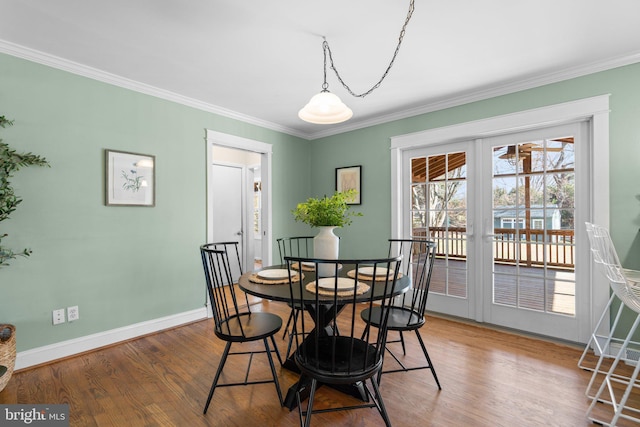 dining area featuring ornamental molding, french doors, baseboards, and wood finished floors