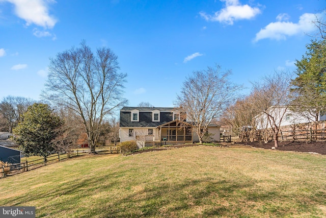 back of house with a yard, roof with shingles, fence private yard, and a sunroom