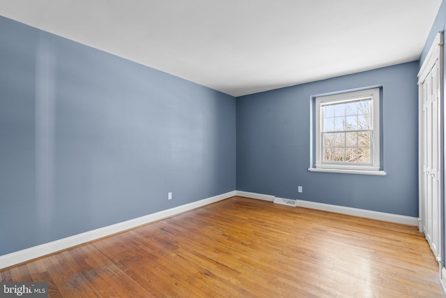 unfurnished room with visible vents, baseboards, and light wood-style floors