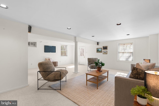 living area featuring plenty of natural light, recessed lighting, light colored carpet, and ornate columns