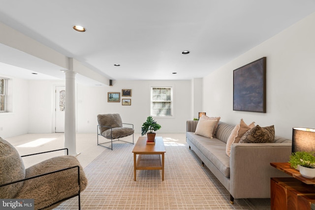 living area featuring recessed lighting, light carpet, and ornate columns