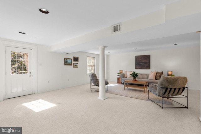 carpeted living area with recessed lighting, visible vents, and ornate columns