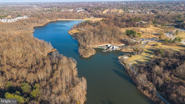 aerial view with a forest view and a water view