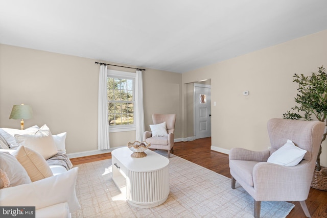 living area with wood finished floors and baseboards