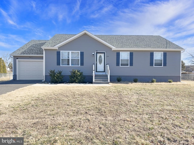 single story home featuring a garage, a front yard, and roof with shingles