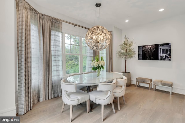 dining room with light wood-type flooring, an inviting chandelier, and recessed lighting