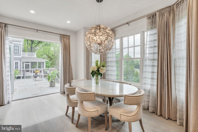 dining area with a chandelier, light wood-type flooring, and recessed lighting