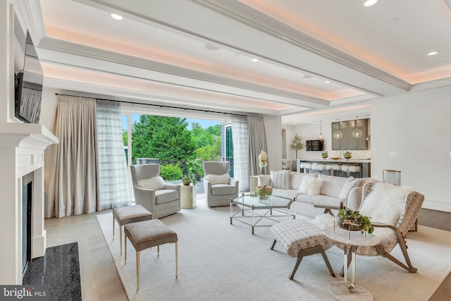 living area with a high end fireplace, beamed ceiling, and recessed lighting