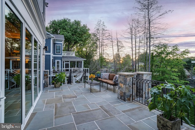 patio terrace at dusk with a balcony