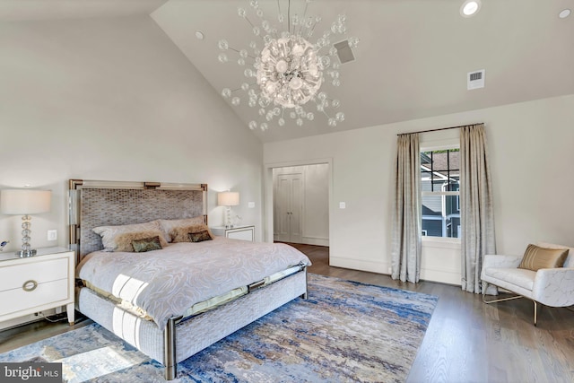 bedroom with high vaulted ceiling, visible vents, a notable chandelier, and wood finished floors