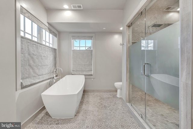 bathroom with a soaking tub, visible vents, toilet, a stall shower, and tile patterned floors