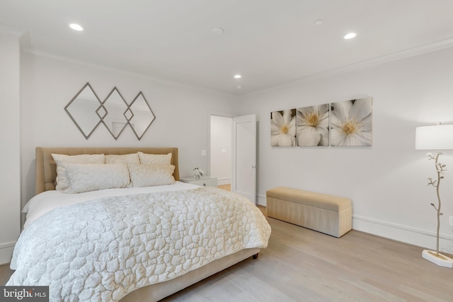 bedroom with ornamental molding, recessed lighting, baseboards, and wood finished floors