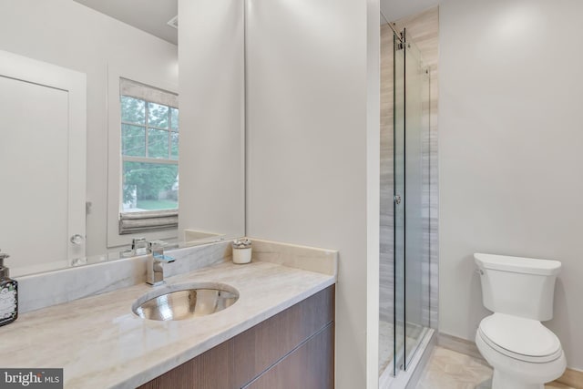 full bathroom with a stall shower, vanity, and toilet