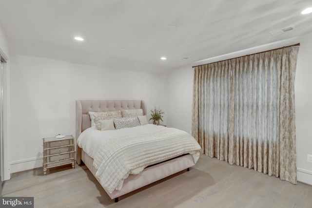 bedroom with recessed lighting, visible vents, and wood finished floors